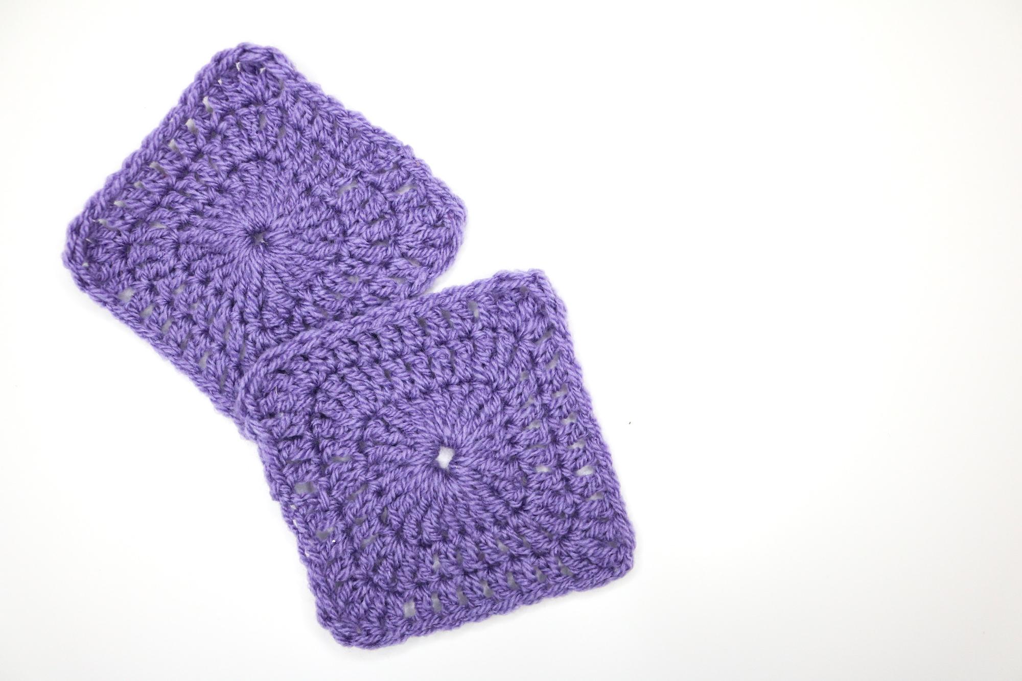 Purple solid granny squares on a while background.