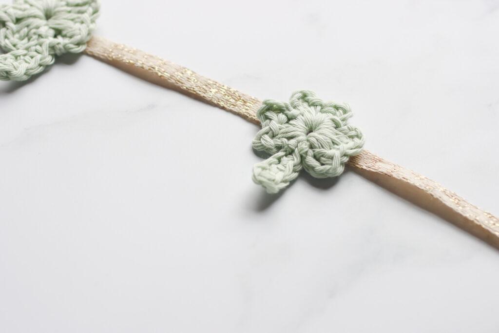 crochet shamrock motif made into bunting using gold sparkly ribbon. 