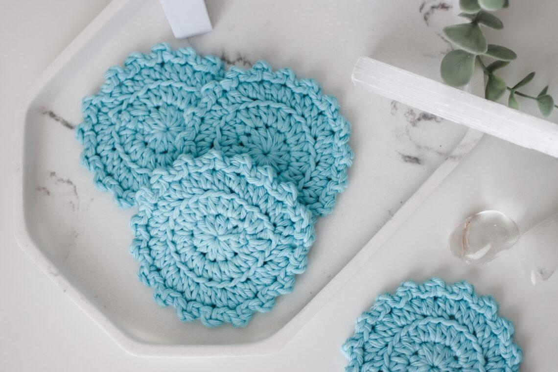 Crochet face scrubbies for a self care hamper photographed in a bathroom setting.