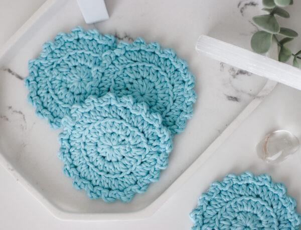 Crochet face scrubbies for a self care hamper photographed in a bathroom setting.