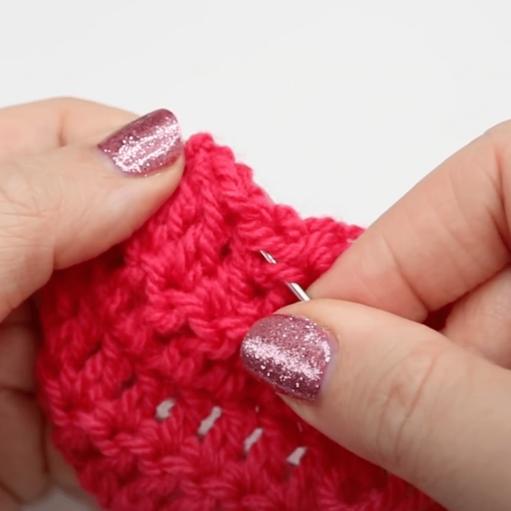 Sewing in the ends of a crochet project.