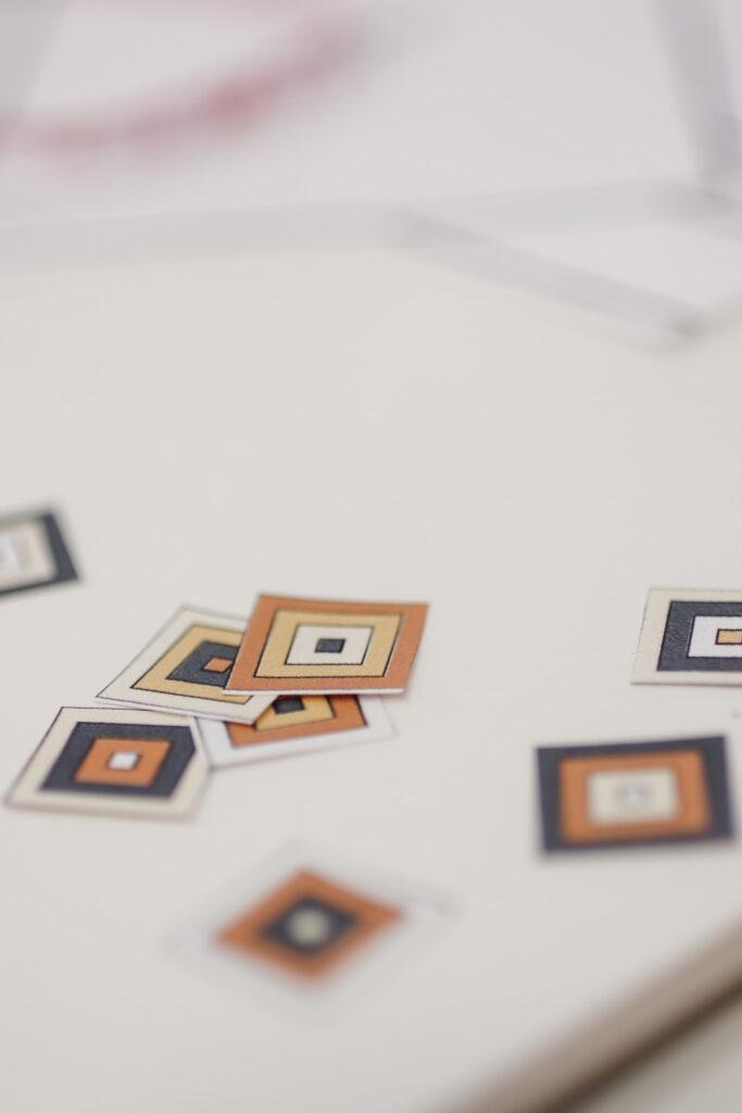 behind the scenes image of the not the high street poncho being designed featuring digital colour ways for the granny squares 