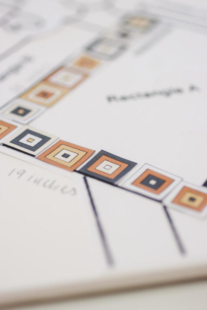behind the scenes image of the not the high street poncho being designed featuring digital colour ways for the granny squares 