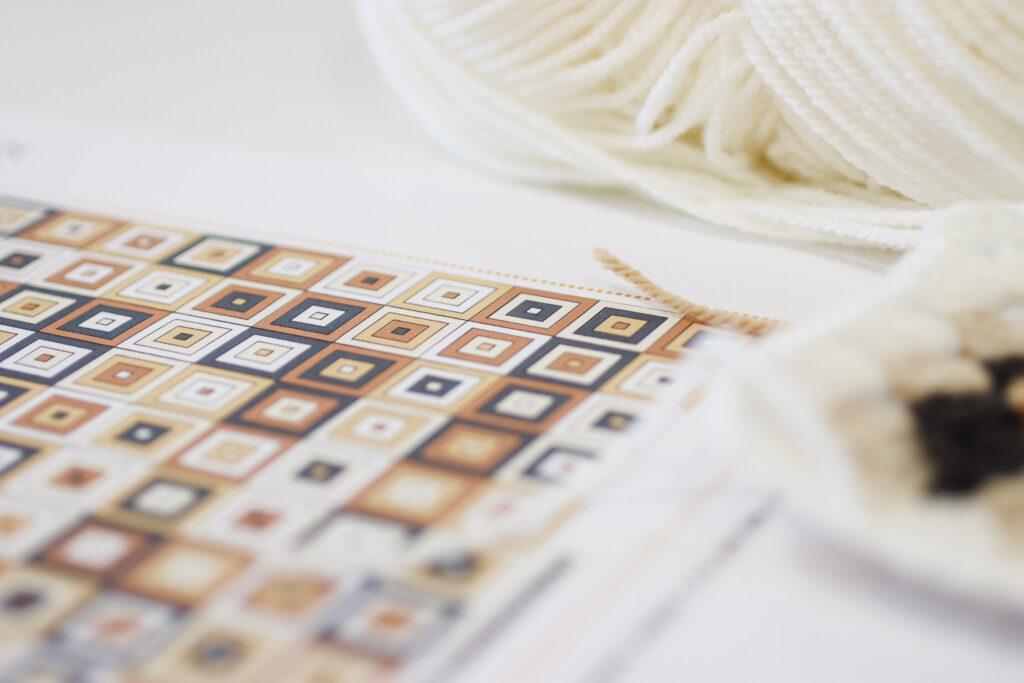 behind the scenes image of the not the high street poncho being designed featuring digital colour ways for the granny squares 