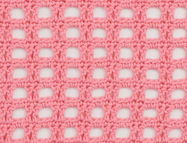 Pink crocheted mesh fabric with a square, openwork pattern